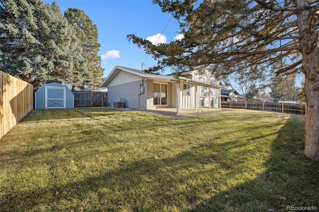 view of yard featuring cooling unit, a patio area, and a shed