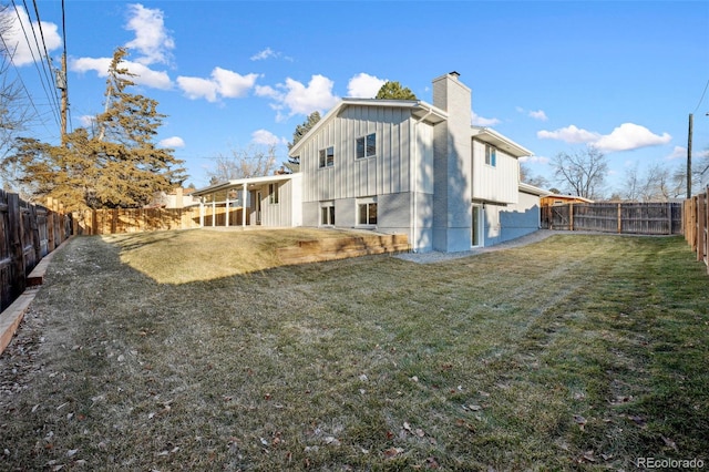 back of house with a lawn