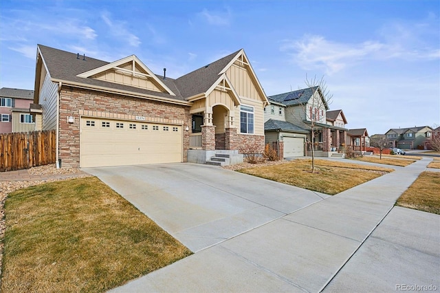 craftsman-style house featuring fence, an attached garage, concrete driveway, stone siding, and board and batten siding