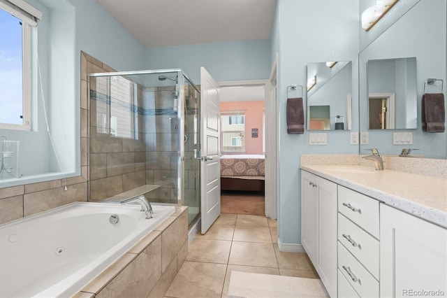 bathroom featuring tile patterned flooring, a shower stall, a jetted tub, and vanity