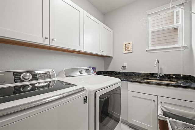 laundry room featuring cabinet space, washer and dryer, and a sink