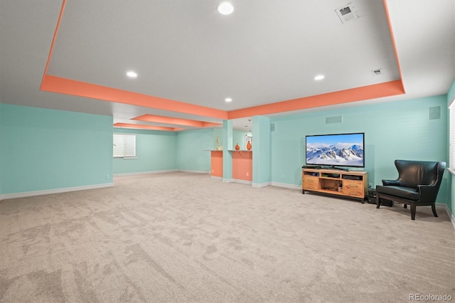 interior space featuring recessed lighting, baseboards, a raised ceiling, and visible vents