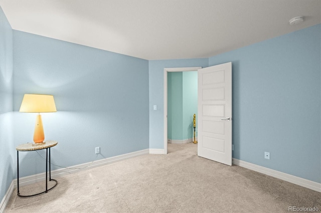 unfurnished room featuring baseboards and carpet floors