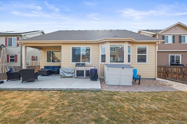 back of house featuring an outdoor living space, fence, a yard, roof with shingles, and a patio area