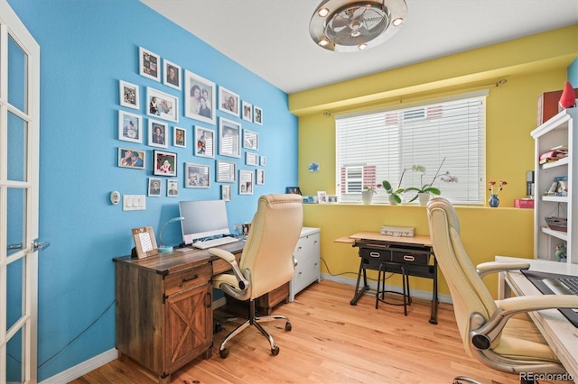 home office featuring baseboards and light wood-type flooring