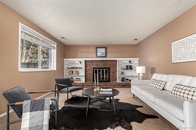 living room featuring a fireplace, carpet floors, and a textured ceiling