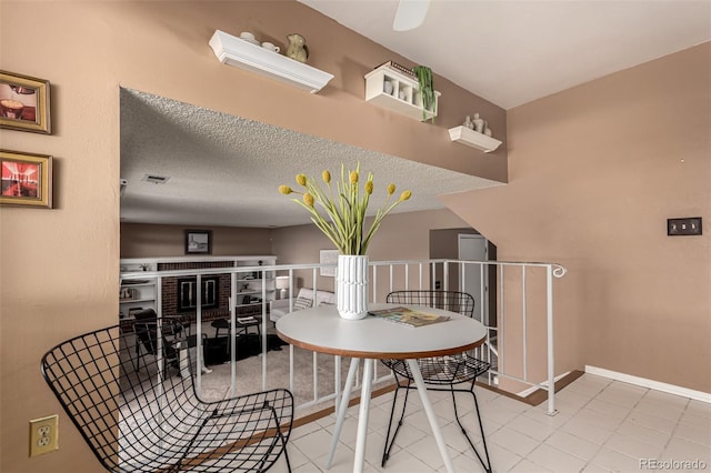 dining area featuring tile patterned floors and a textured ceiling