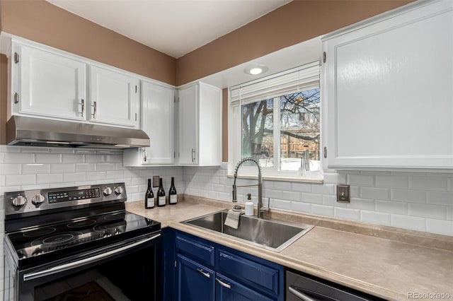 kitchen with black range with electric cooktop, sink, white cabinets, and blue cabinets