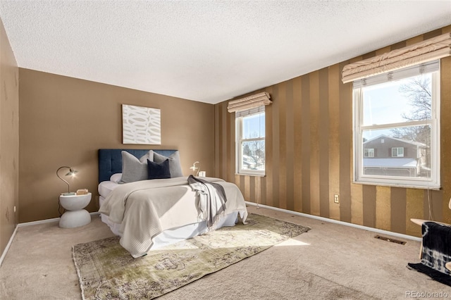 carpeted bedroom with a textured ceiling