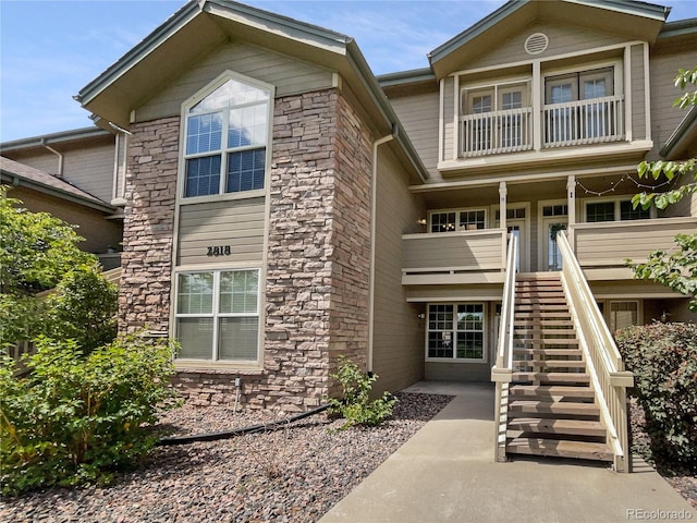 view of front of home featuring a balcony and a patio area