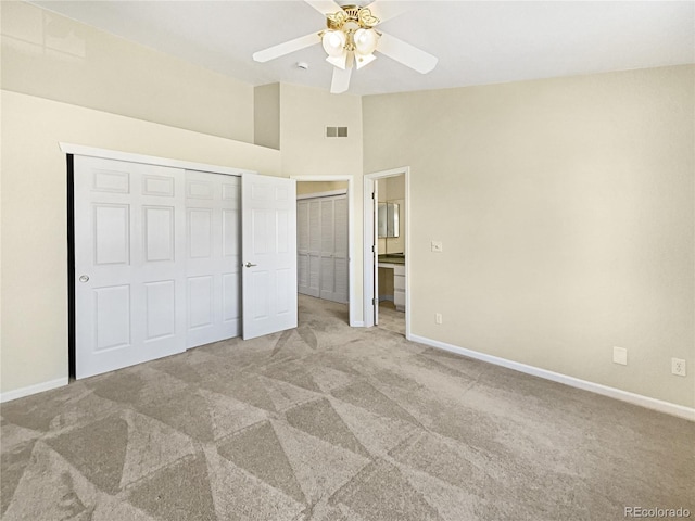 unfurnished bedroom featuring carpet floors, visible vents, vaulted ceiling, ceiling fan, and baseboards