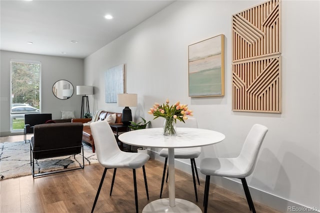 dining room with wood finished floors, baseboards, and recessed lighting