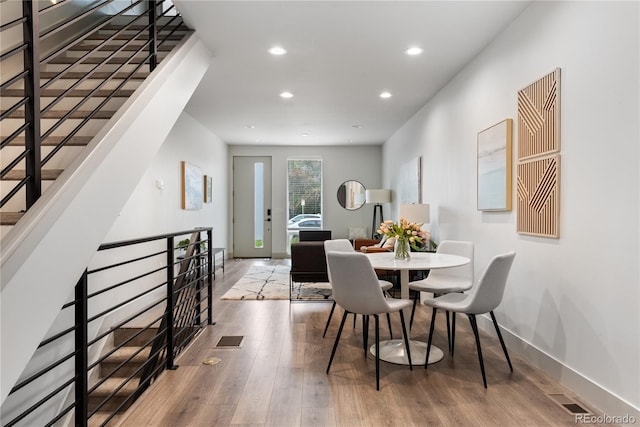 dining space with recessed lighting, wood finished floors, and baseboards