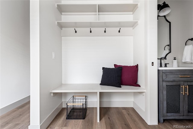 mudroom with wood finished floors and baseboards