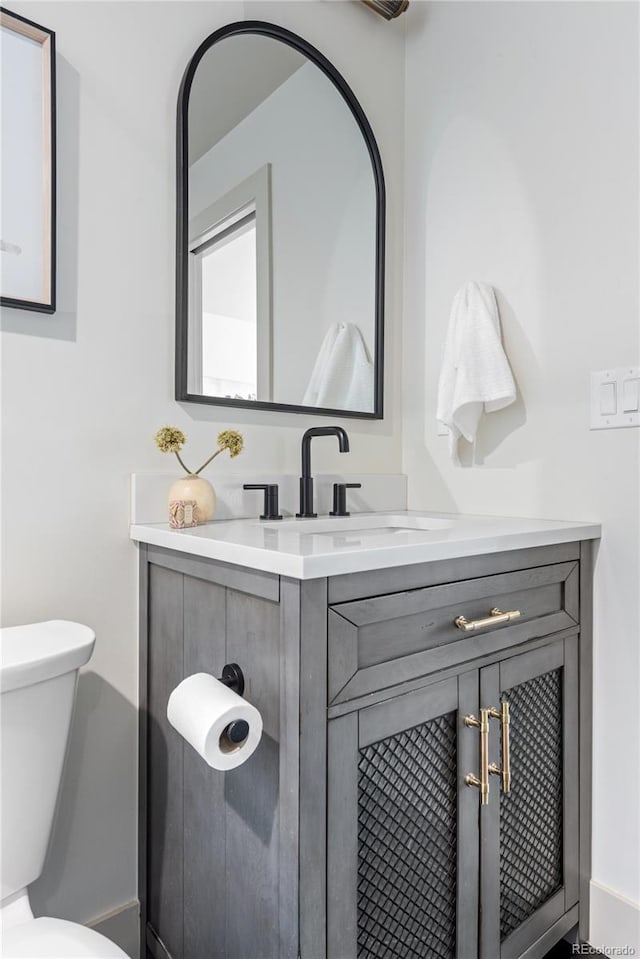 bathroom featuring toilet and vanity