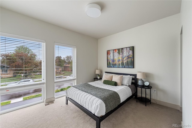 carpeted bedroom featuring baseboards