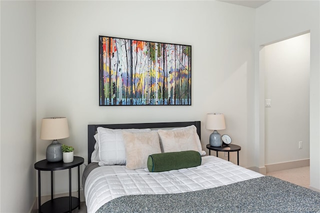 bedroom featuring baseboards and carpet flooring