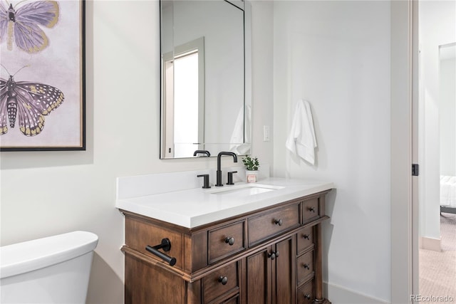 bathroom with toilet and vanity