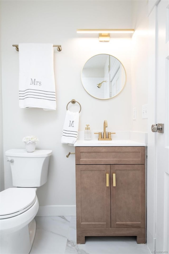 3071 W 38th Ave, Denver, CO 80211 - bathroom featuring baseboards, marble look tiles, vanity, and toilet