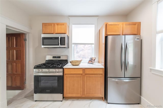 3071 W 38th Ave, Denver, CO 80211 - kitchen with appliances with stainless steel finishes, light countertops, light marble finish flooring, and decorative backsplash