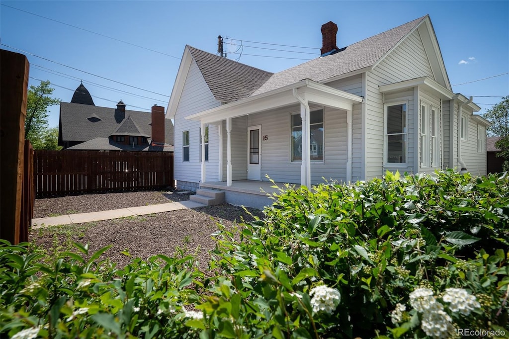 15 E Dale St, Colorado Springs, CO 80903 - bungalow-style home with a porch, roof with shingles, and a chimney
