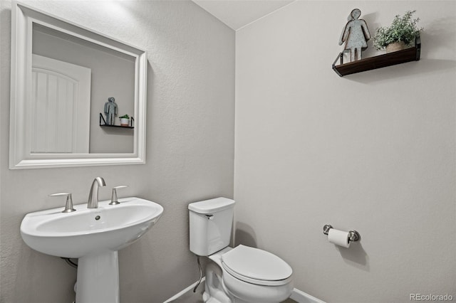 bathroom featuring sink and toilet