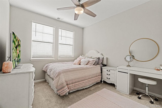 bedroom with ceiling fan and light carpet