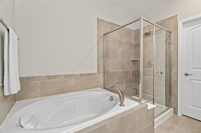 bathroom featuring tile patterned flooring and independent shower and bath