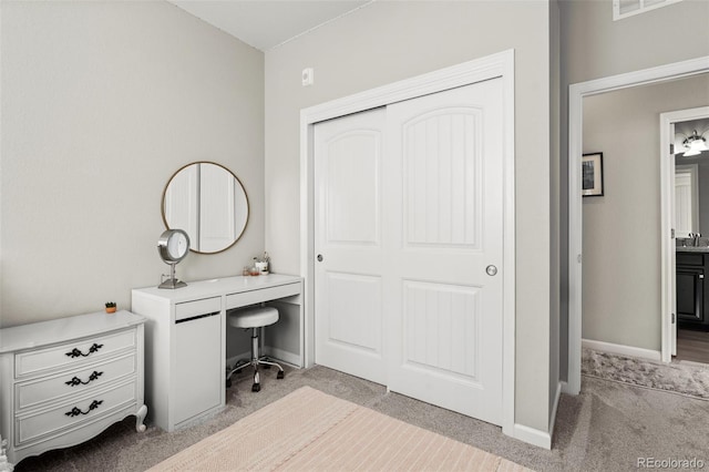 unfurnished office featuring sink and light colored carpet