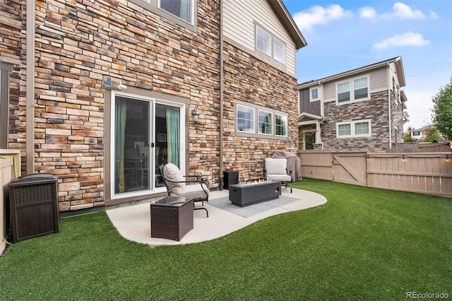 back of house featuring a lawn and a patio