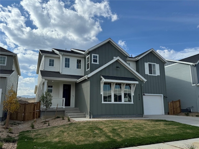 view of front of property with a front yard and a garage