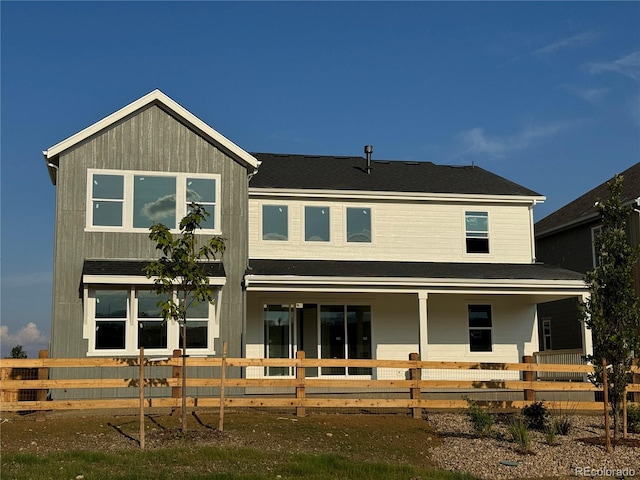 rear view of property featuring a porch