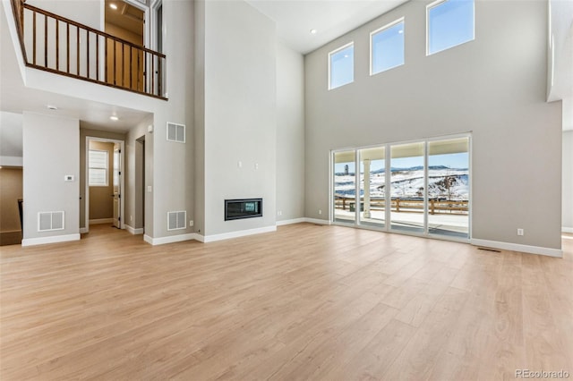 unfurnished living room with light wood-type flooring