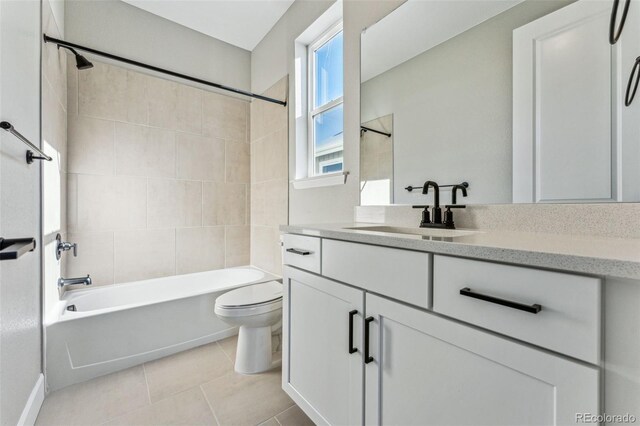 full bathroom featuring tiled shower / bath, vanity, toilet, and tile patterned flooring