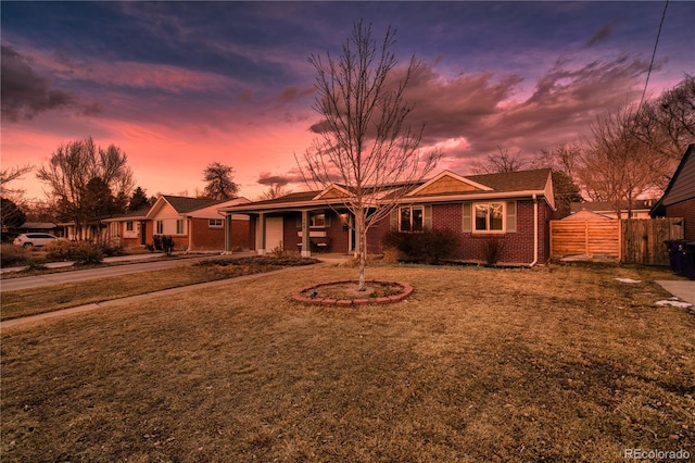 view of front of house featuring concrete driveway, fence, a garage, and a front lawn