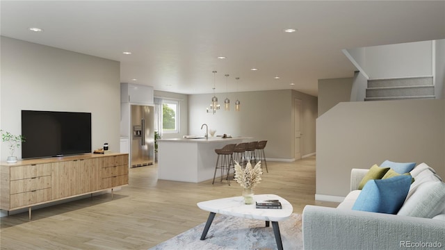 living area featuring light wood-style flooring, recessed lighting, baseboards, and stairs