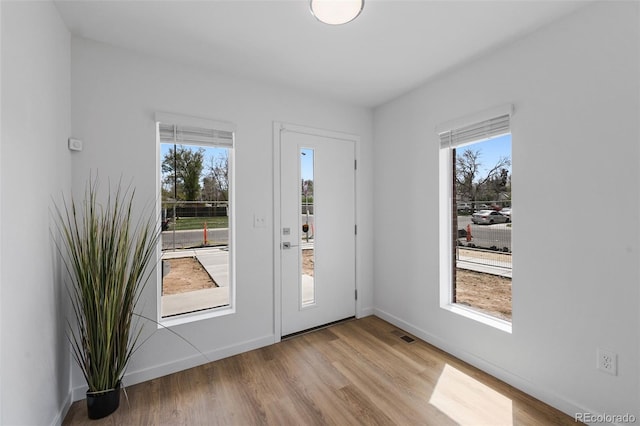 1337 N Alton St, Aurora, CO 80010 - entryway featuring plenty of natural light, wood finished floors, and baseboards