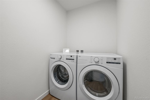 1337 N Alton St, Aurora, CO 80010 - laundry room with washer and clothes dryer, baseboards, and wood finished floors