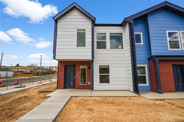 1337 N Alton St, Aurora, CO 80010 - view of front of house with brick siding and a patio area