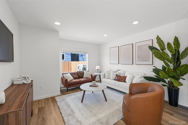 1337 N Alton St, Aurora, CO 80010 - living area featuring wood finished floors, recessed lighting, and baseboards