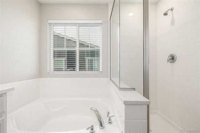 bathroom featuring separate shower and tub