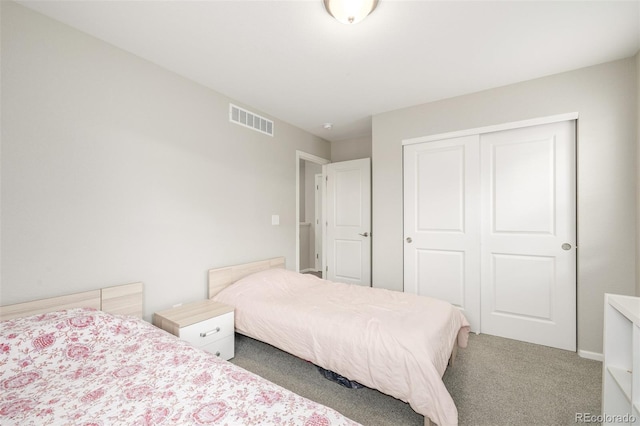 bedroom with carpet and a closet