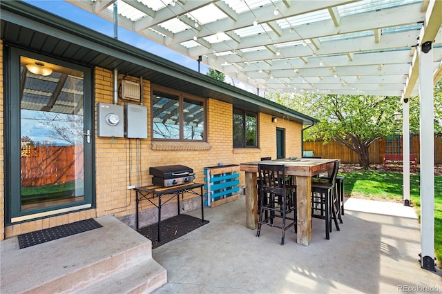 view of patio featuring a pergola, area for grilling, and fence