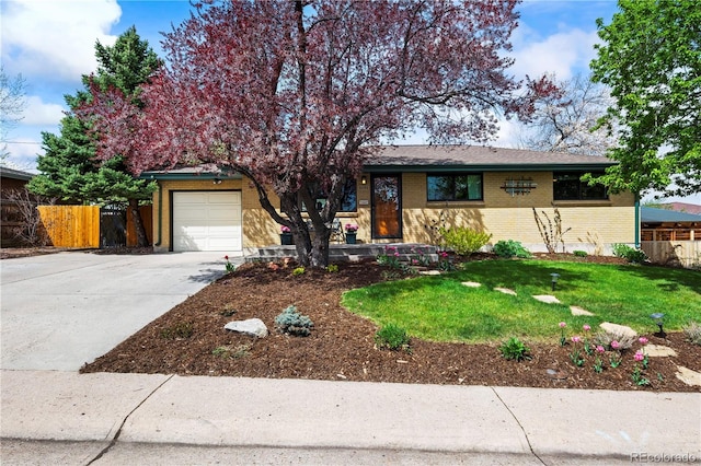 view of front facade with fence, an attached garage, brick siding, and concrete driveway