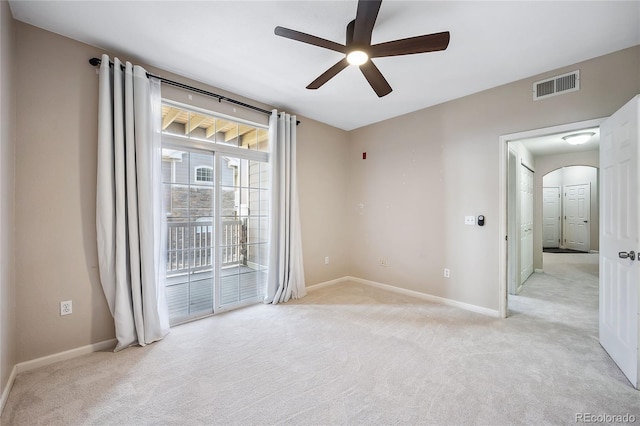 empty room featuring light colored carpet and ceiling fan