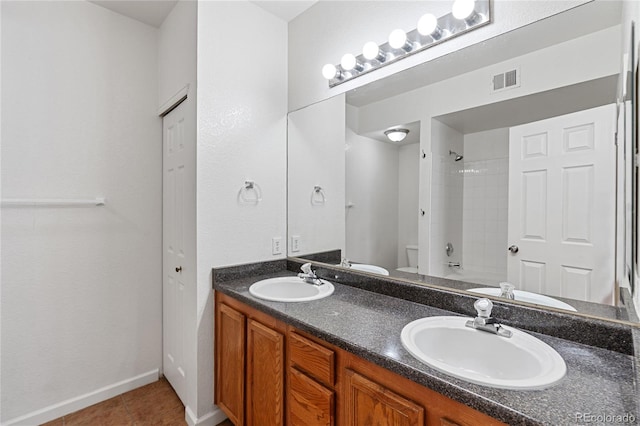 full bathroom featuring vanity, toilet, tiled shower / bath combo, and tile patterned flooring