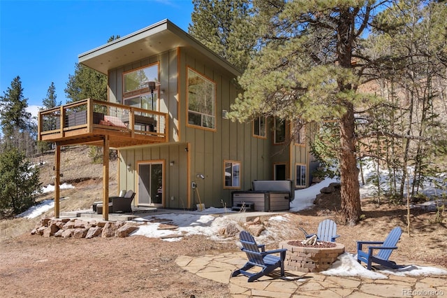 529 Grosbeak Cir, Divide, CO 80814 - rear view of property featuring an outdoor fire pit, a jacuzzi, board and batten siding, and a patio area