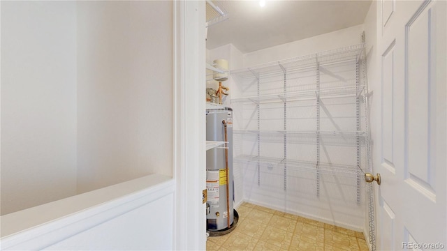 interior space with water heater and tile patterned floors