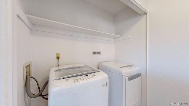 washroom featuring laundry area and washing machine and clothes dryer