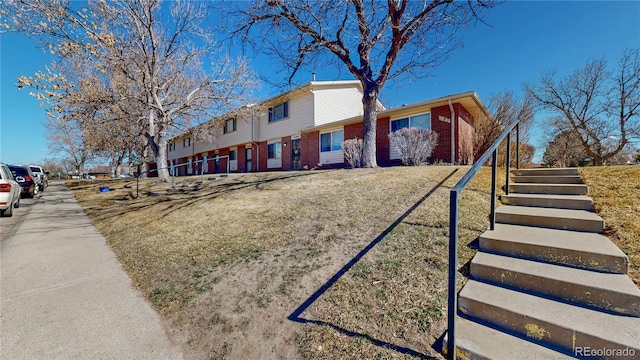 exterior space with brick siding and a residential view